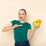 front-view-young-attractive-female-dark-green-shirt-holding-plate-with-fruits_1164